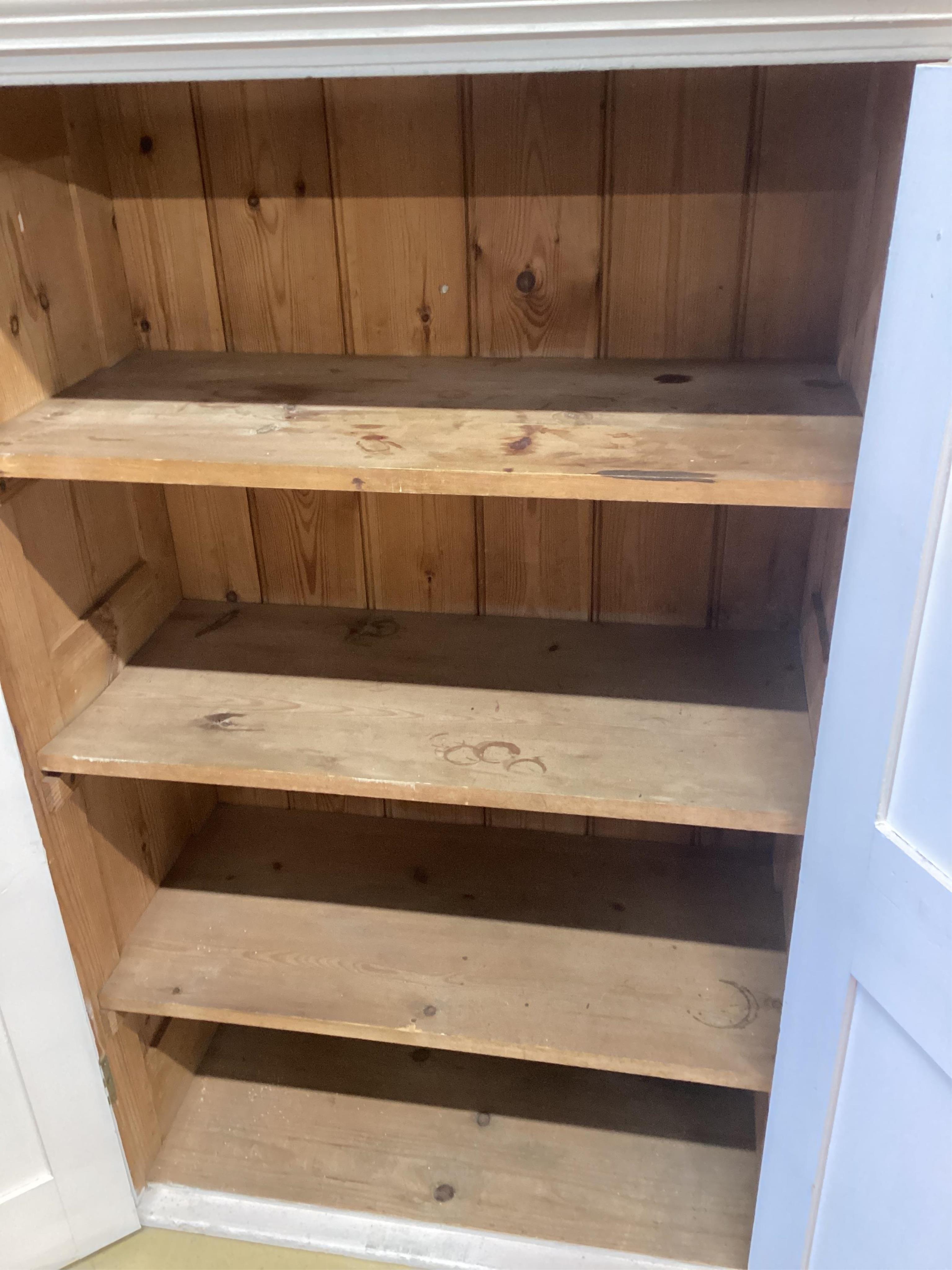 A Victorian painted pine panelled cupboard the interior with three shelves, width 86cm, depth 43cm, height 135cm. Condition - fair